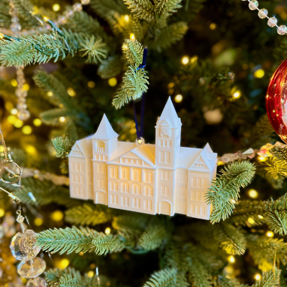 Side view of the Auburn Christmas ornament for students featuring Samford Hall.
