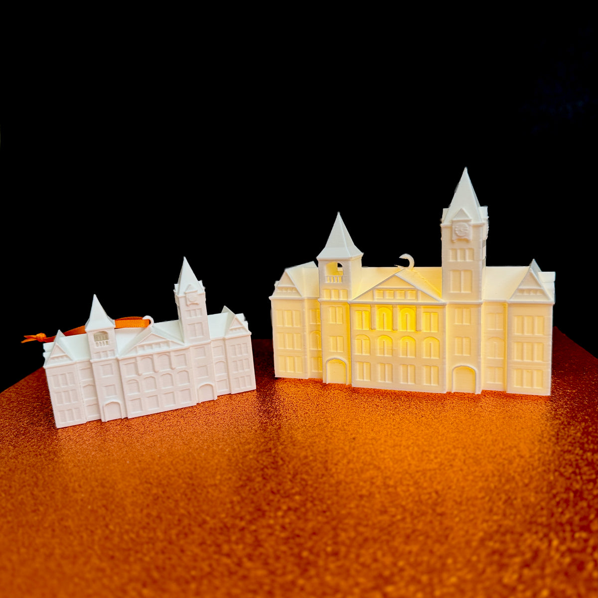 3D printed Auburn University Samford Hall ornament with orange and navy ribbon, shown on white background
