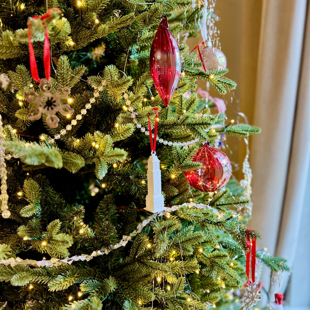 Bama ornament of Denny Chimes shown on a Christmas tree.
