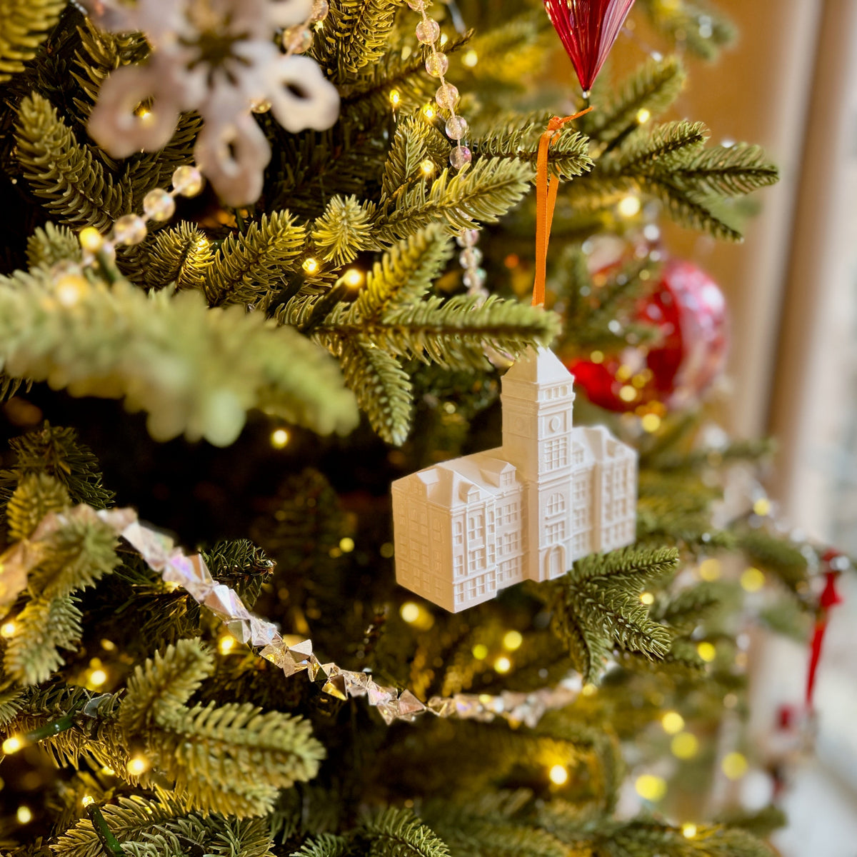 The Clemson graduation ornament shown on a Christmas tree.