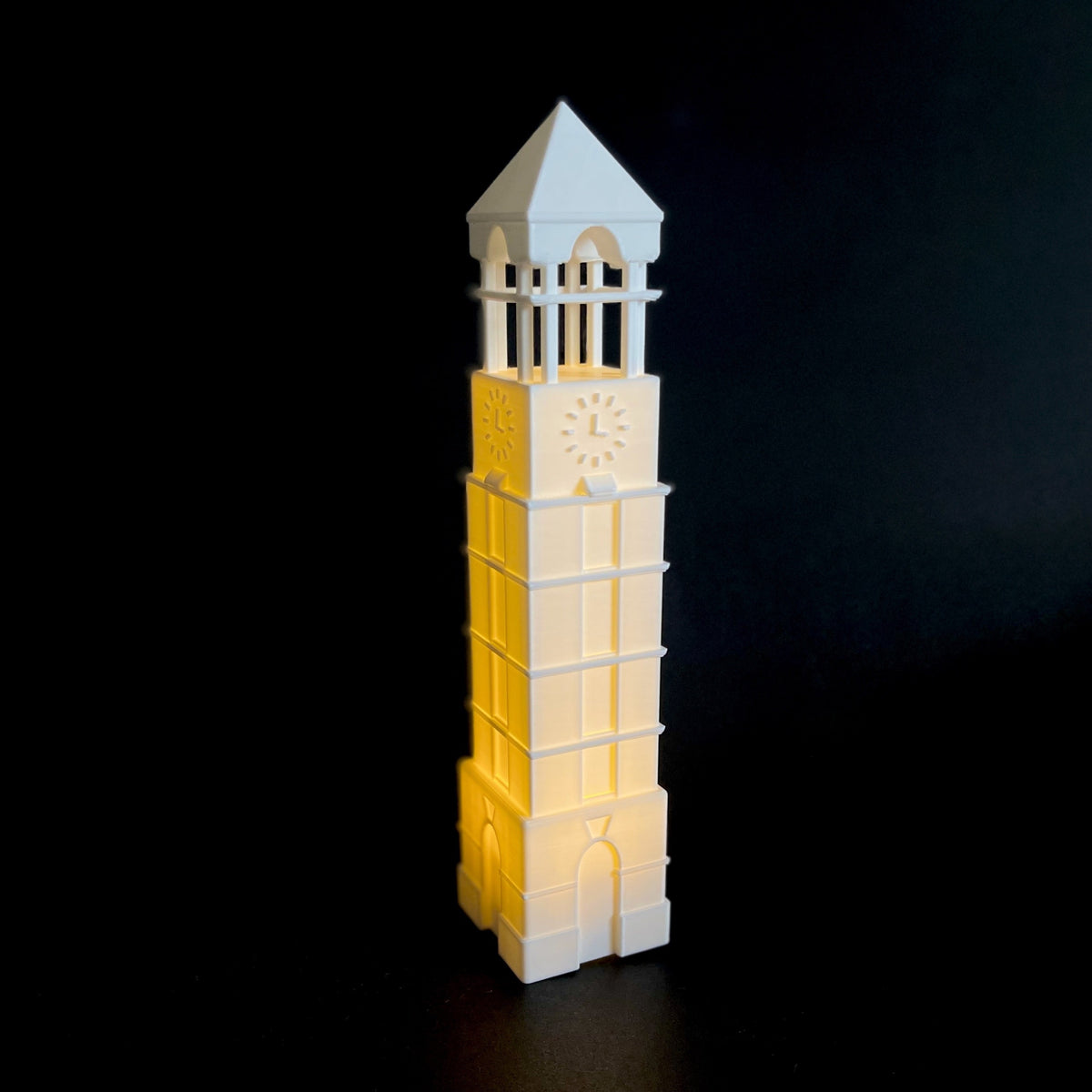 Front view of the lighted Purdue Tower figurine, shown against a black background.