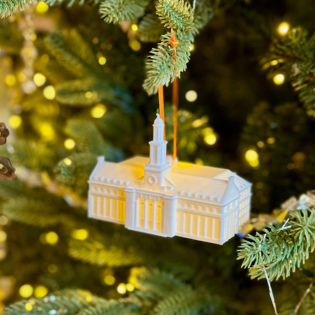 The Oklahoma State Sooners ornament of the Edmon Low Library, shown on a Christmas Tree