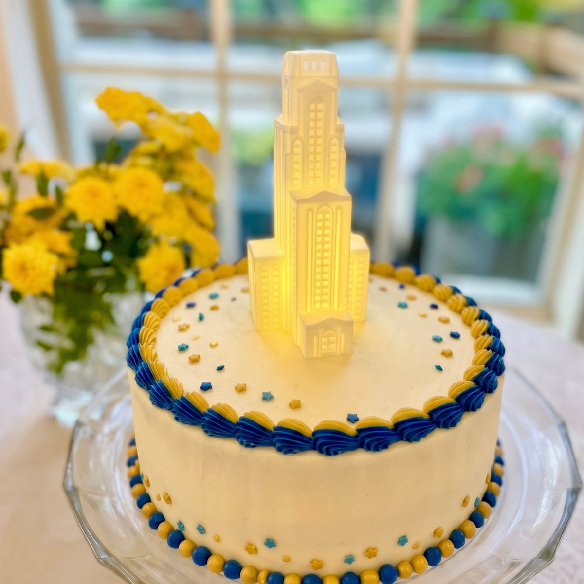 The University of Pittsburgh cake topper representing the Cathedral of Learning building and shown at a graduation party.
