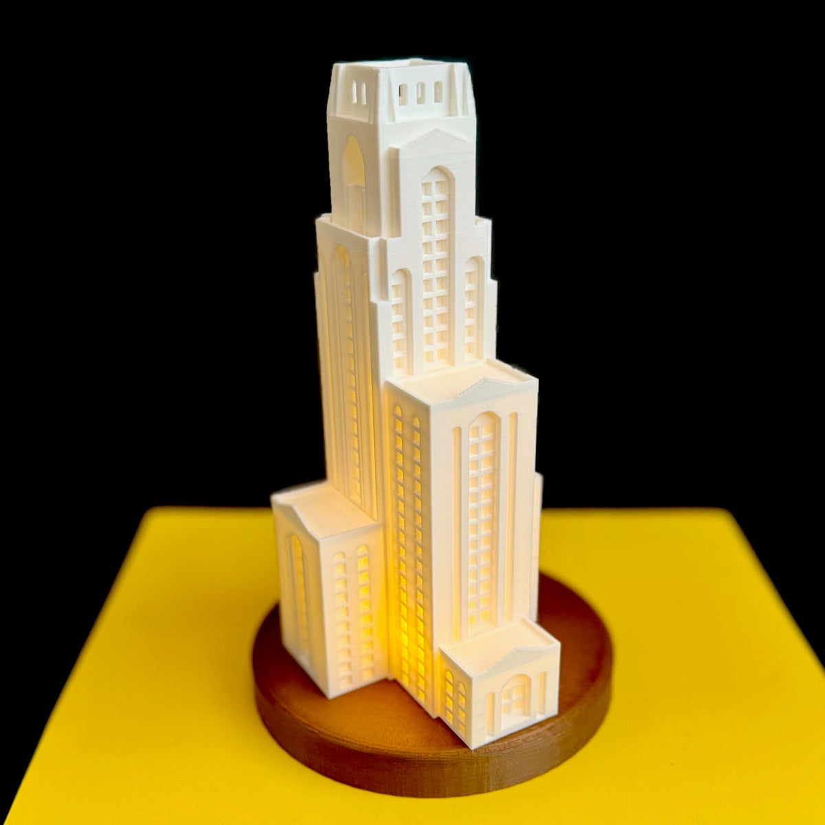 The University of Pittsburg Pitt Cathy lamp, shown against a yellow background.