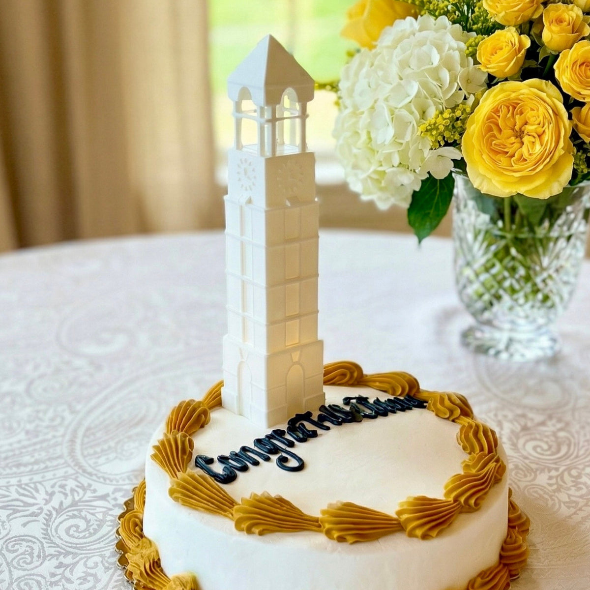 The Purdue cake topper lighted figurine, designed as a replica of the bell tower building on the Lafayette campus.