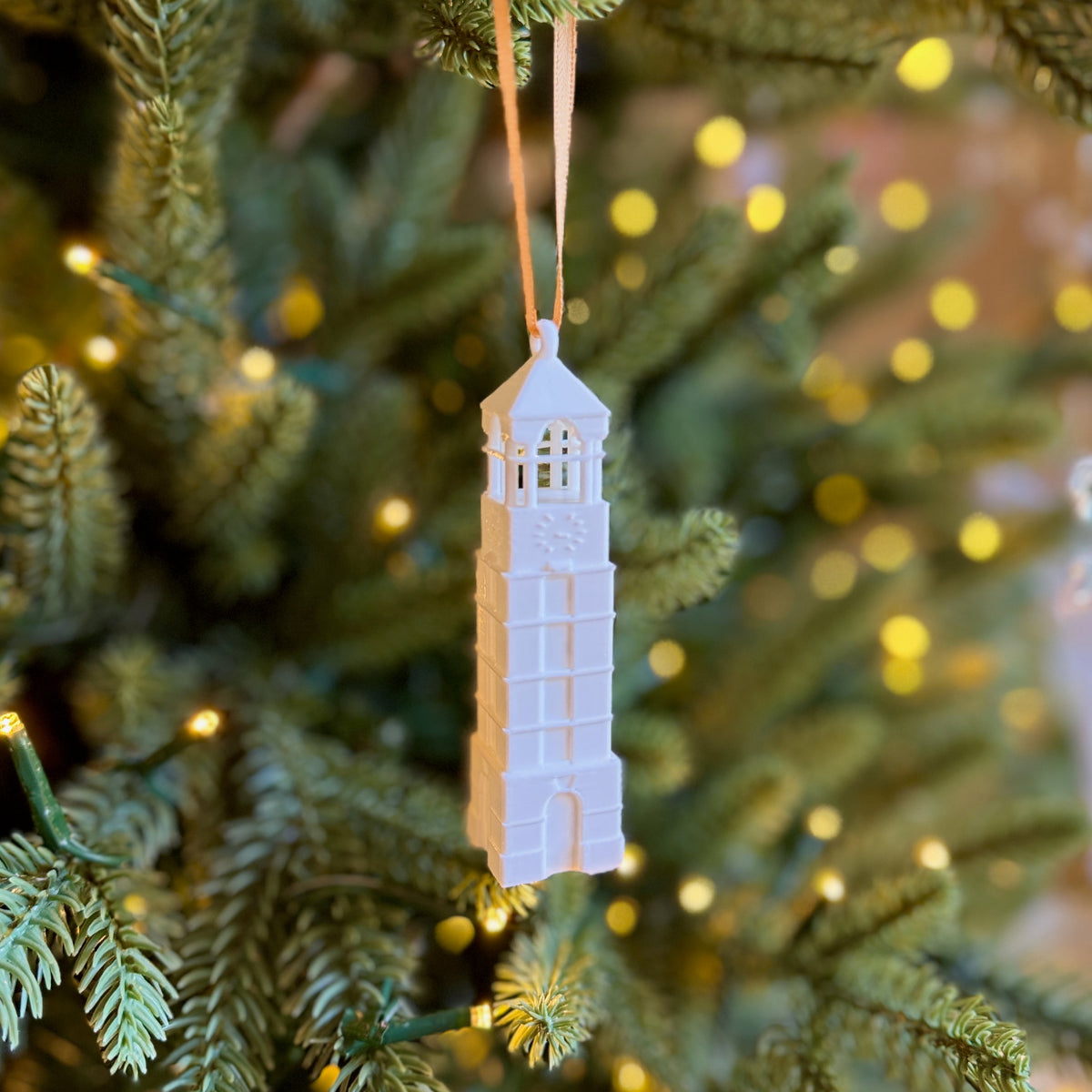 The Purdue Bell Tower ornament shown on a Christmas tree.