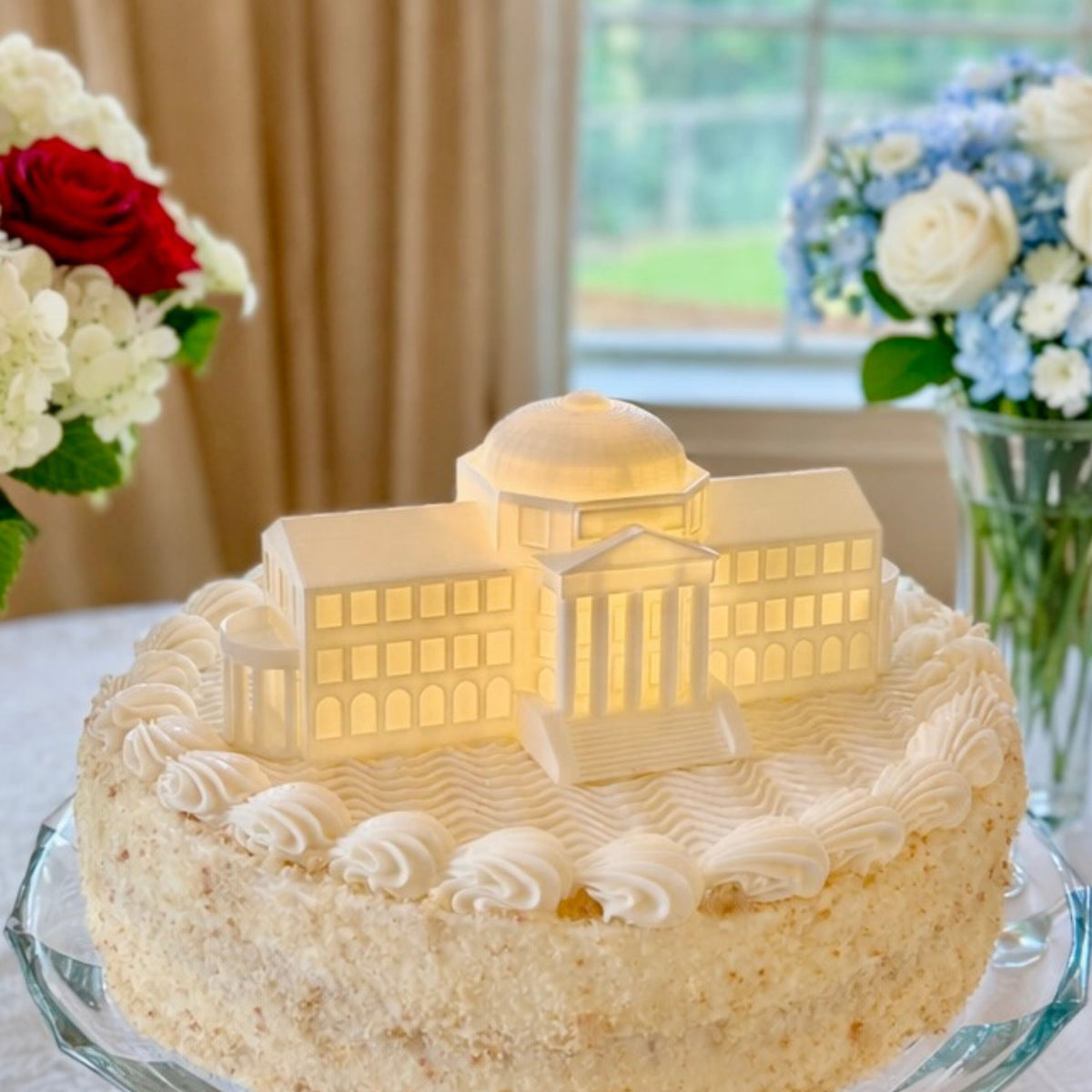 The SMU cake topper with LED light, designed as a replica of the Dallas Hall building and shown on a graduation cake or groom's cake.