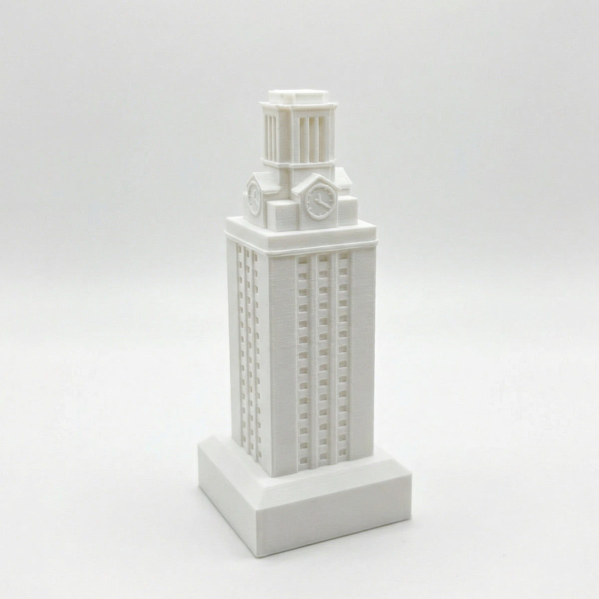 The University of Texas Tower figurine, shown in white against a studio background.