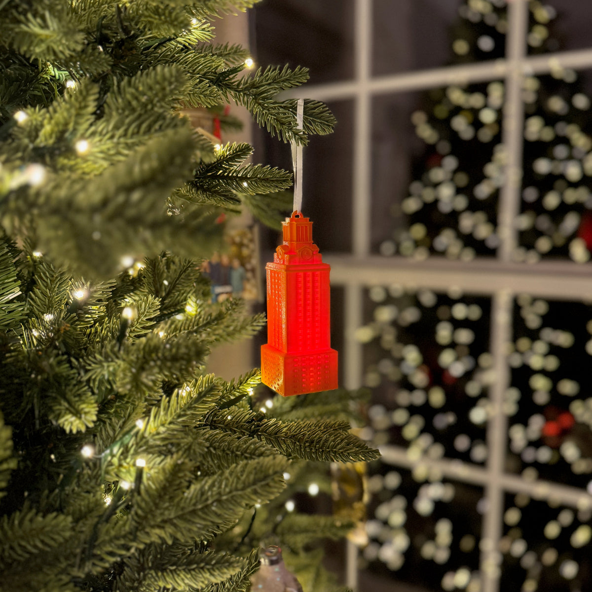 The UT Tower ornament with a light, and shown in burnt orange.