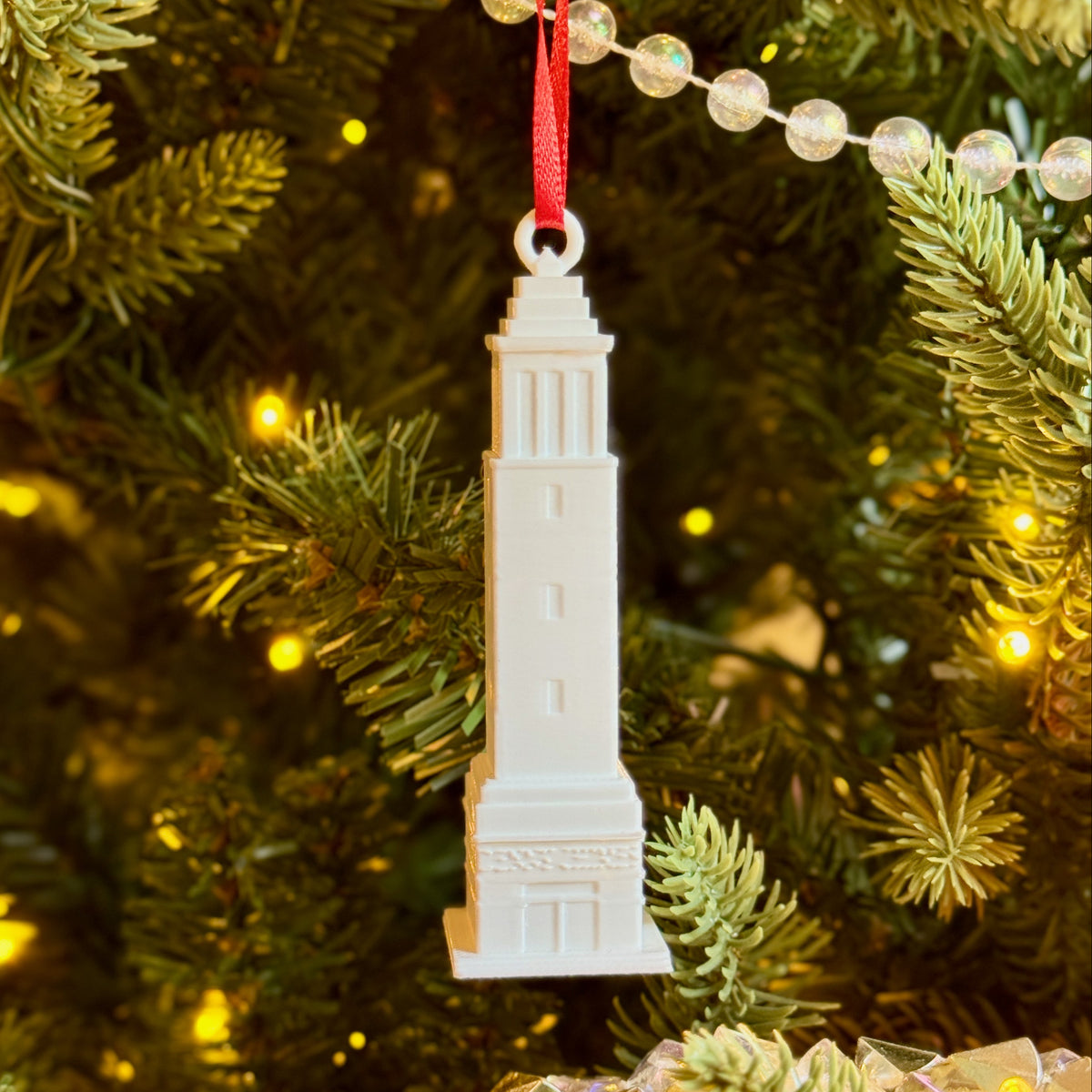 University of Alabama ornament of Denny Chimes on a Christmas tree.