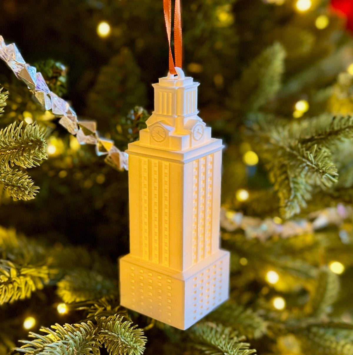 University of Texas ornament of the UT Tower shown on a Christmas tree.