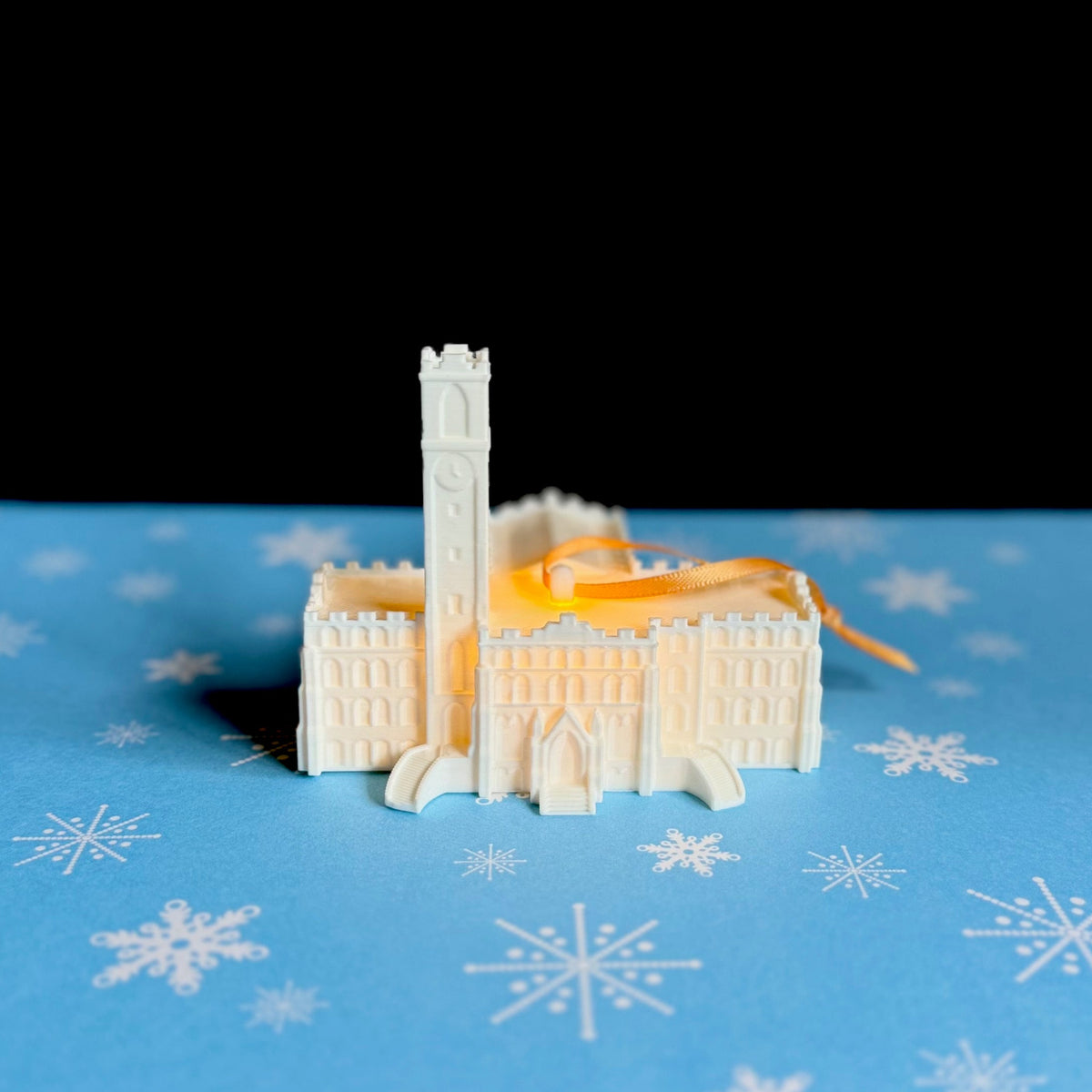 The Vanderbilt University ornament, shown against a blue holiday background.