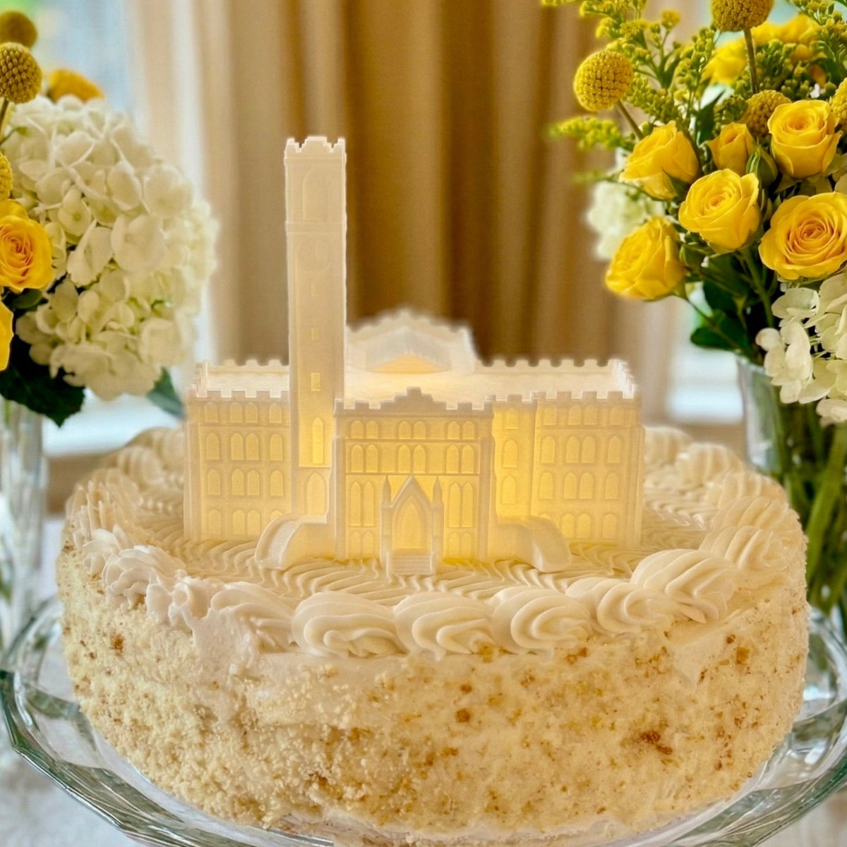 The Vanderbilt cake topper with an LED light, designed as the Kirkland Hall building shown on a graduation cake for Vandy alumni.