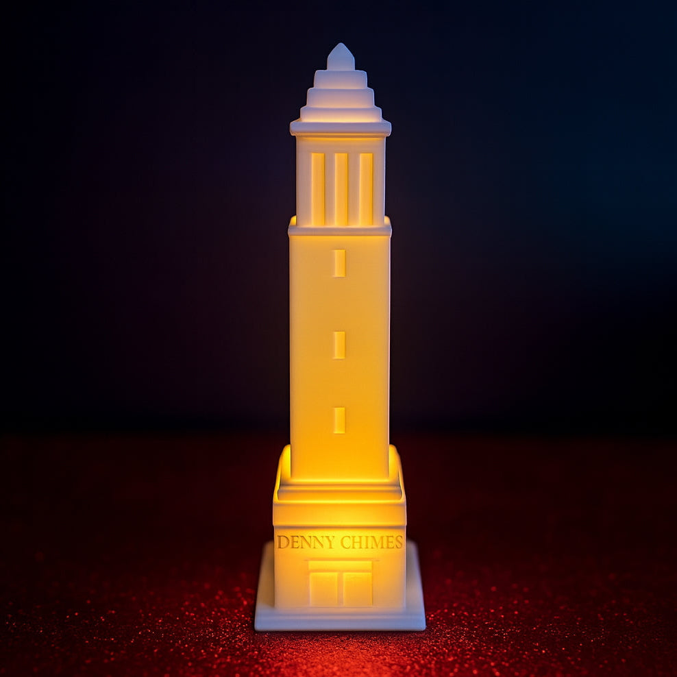 LED-lit 3D printed Denny Chimes tower figurine on a red textured surface with a dark gradient background.