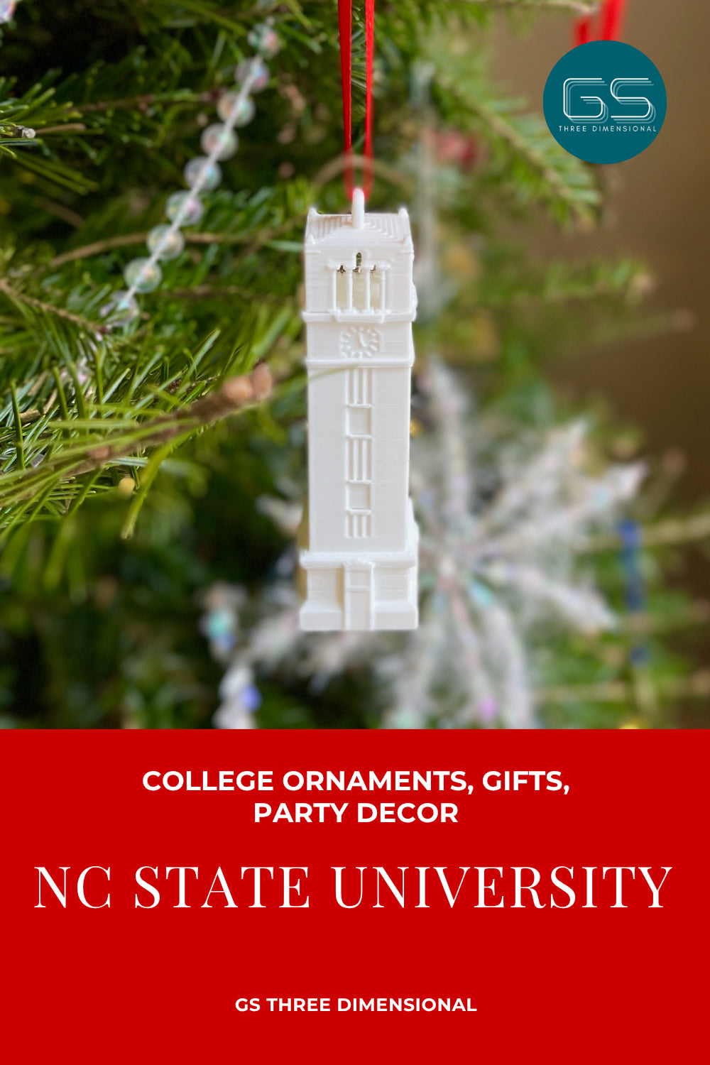 Decorative ornament of the Memorial Tower building on a Christmas tree with 'NC State University' text and 'GS Three Dimensional' branding.