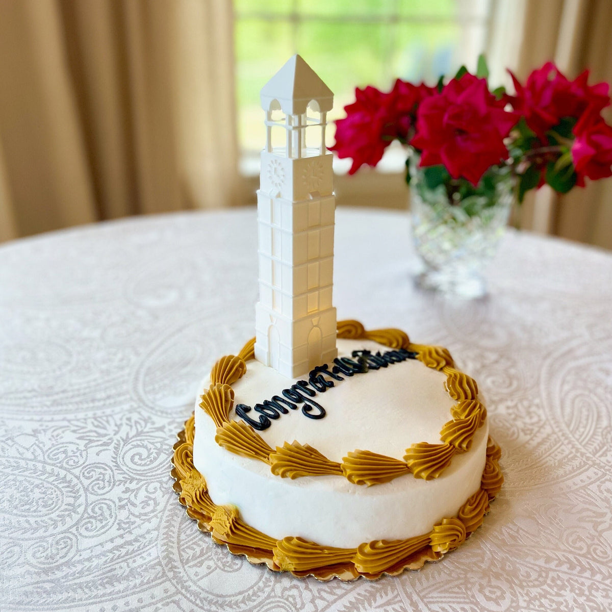 The lighted Purdue cake topper, shown on a Purdue graduation cake.