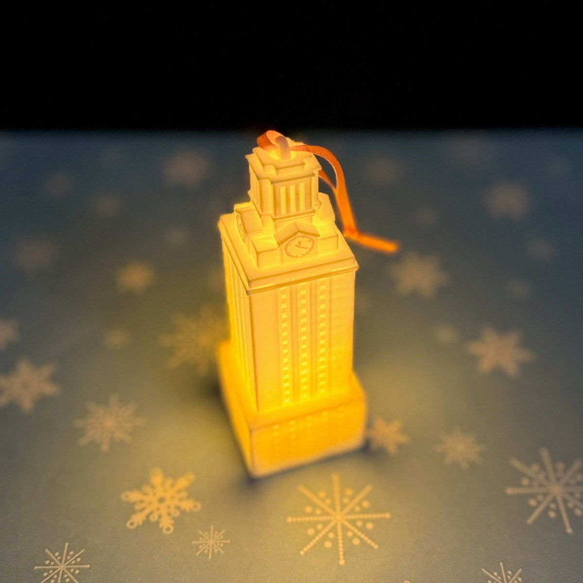 The lighted ornament for the University of Texas, shown lit in a dark room.