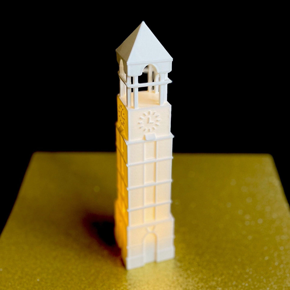 The lighted Purdue figurine, shown against a gold background.