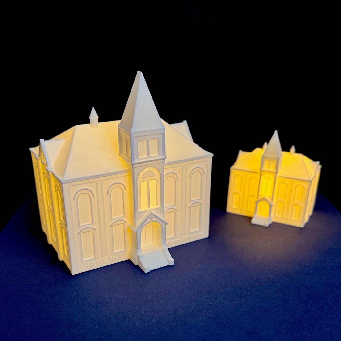 Close up of illuminated Hargis Hall Auburn architectural model with warm LED glow