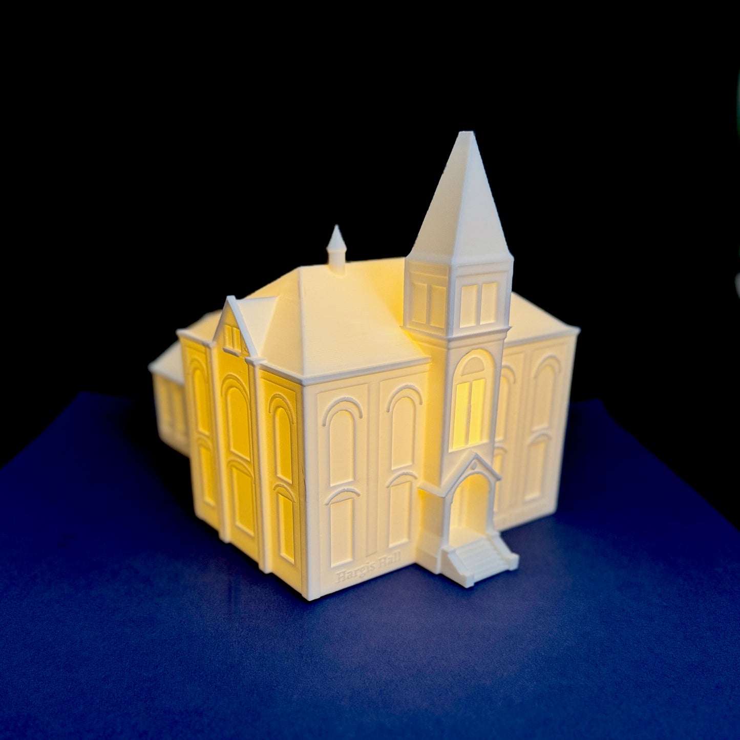 Auburn alumni office decor featuring illuminated Hargis Hall model