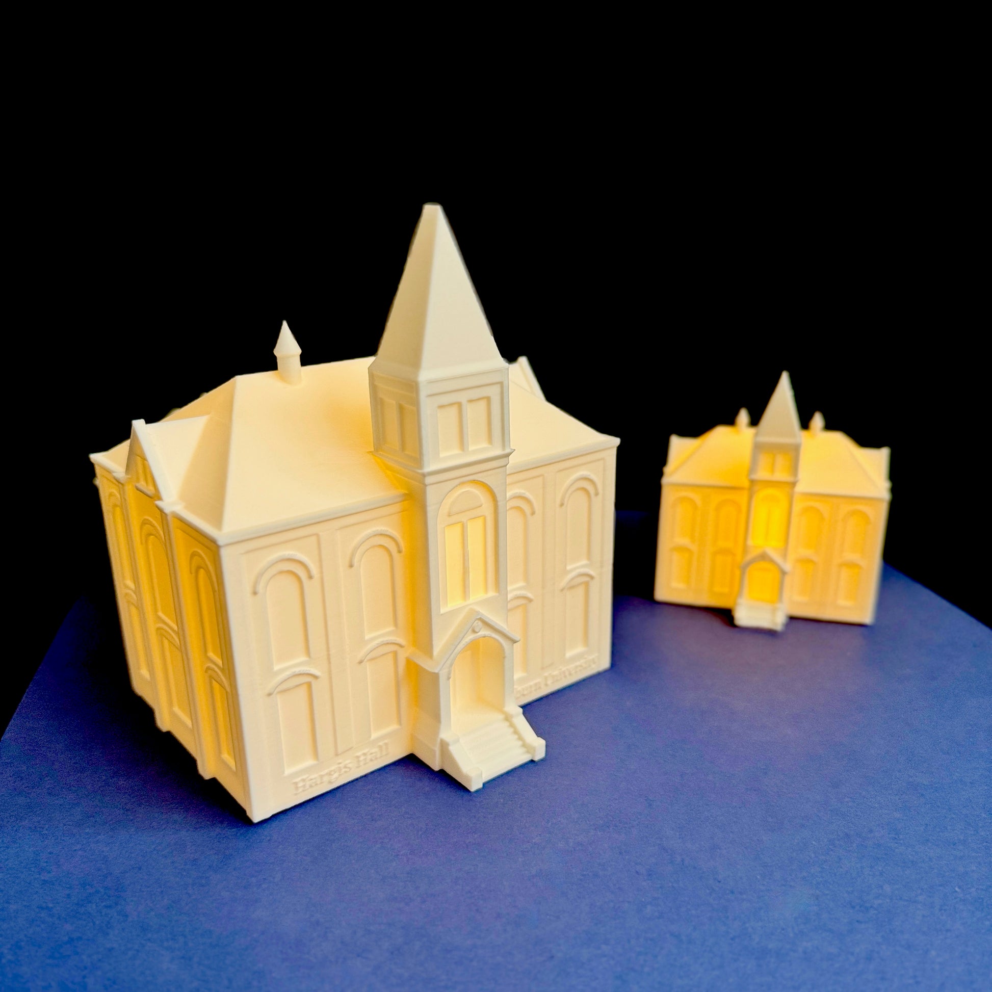 Large and small Auburn Hargis Hall LED figurines side by side for size comparison