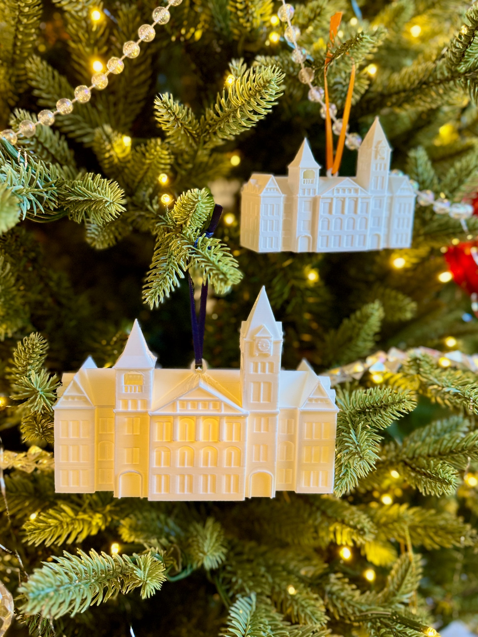 The Auburn Ornaments featuring Samford Hall, shown on a Christmas tree.