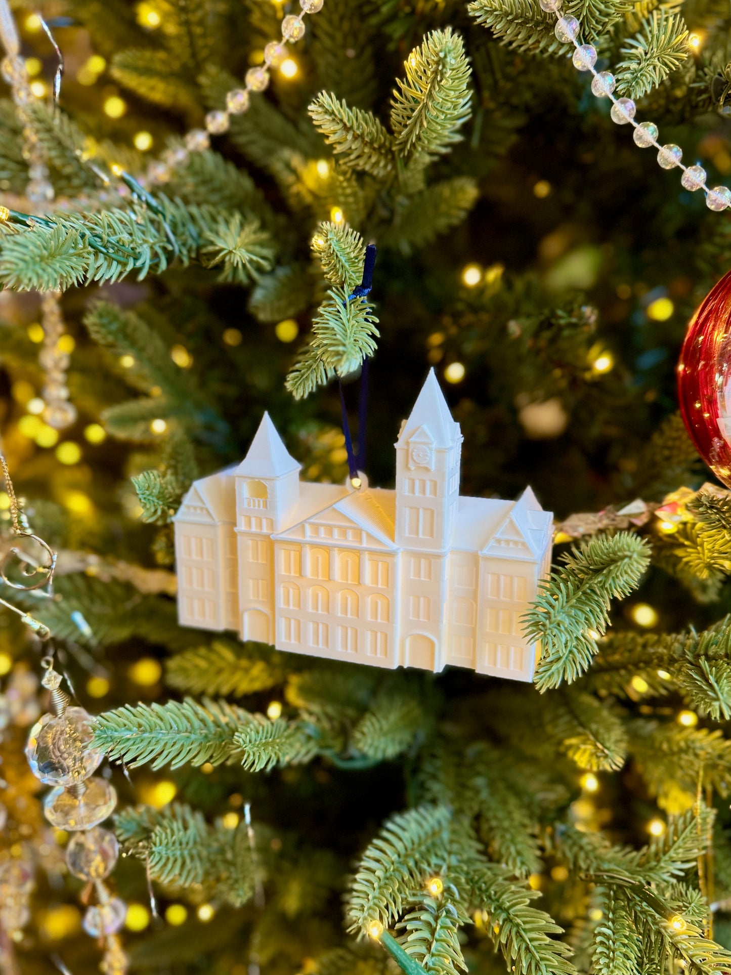 Side view of the Auburn Christmas ornament for students featuring Samford Hall.
