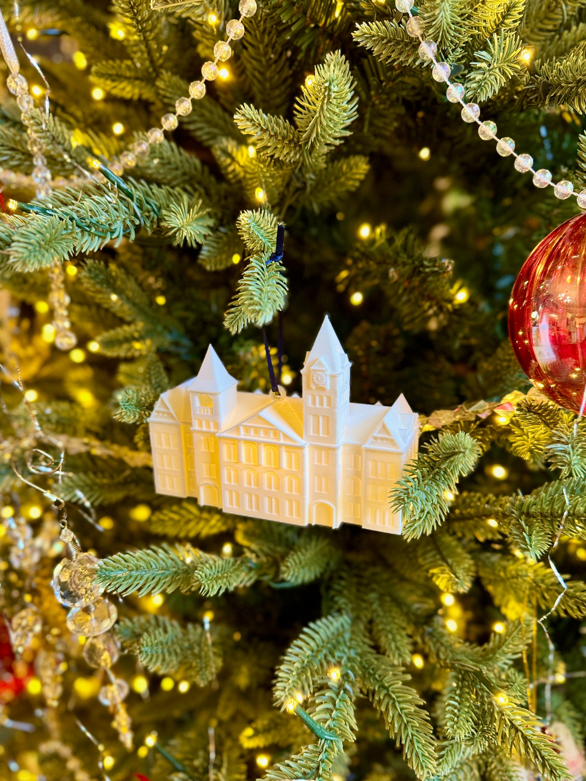 Side view of the Auburn keepsake ornament featuring Samford Hall.