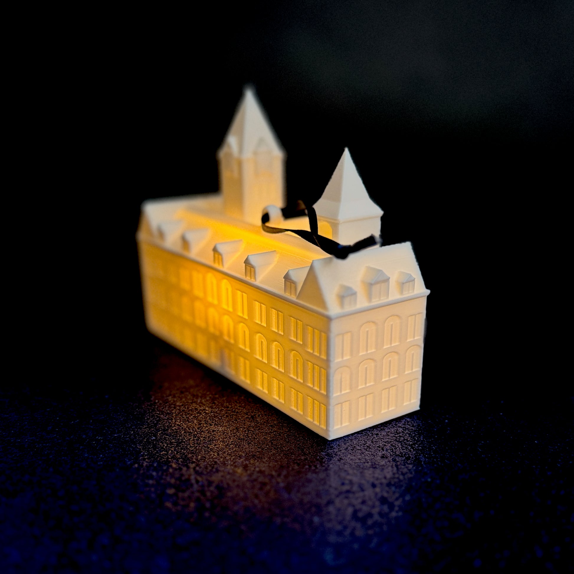 Close-up of Auburn ornament with LED lighting — detailed replica of Samford Hall for Christmas tree.