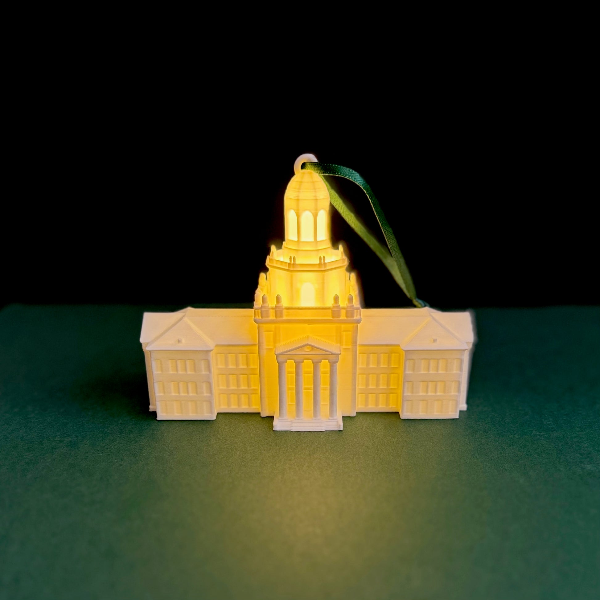 Close-up showing the 3D-printed architectural details and illuminated columns of a Pat Neff Hall college ornament.