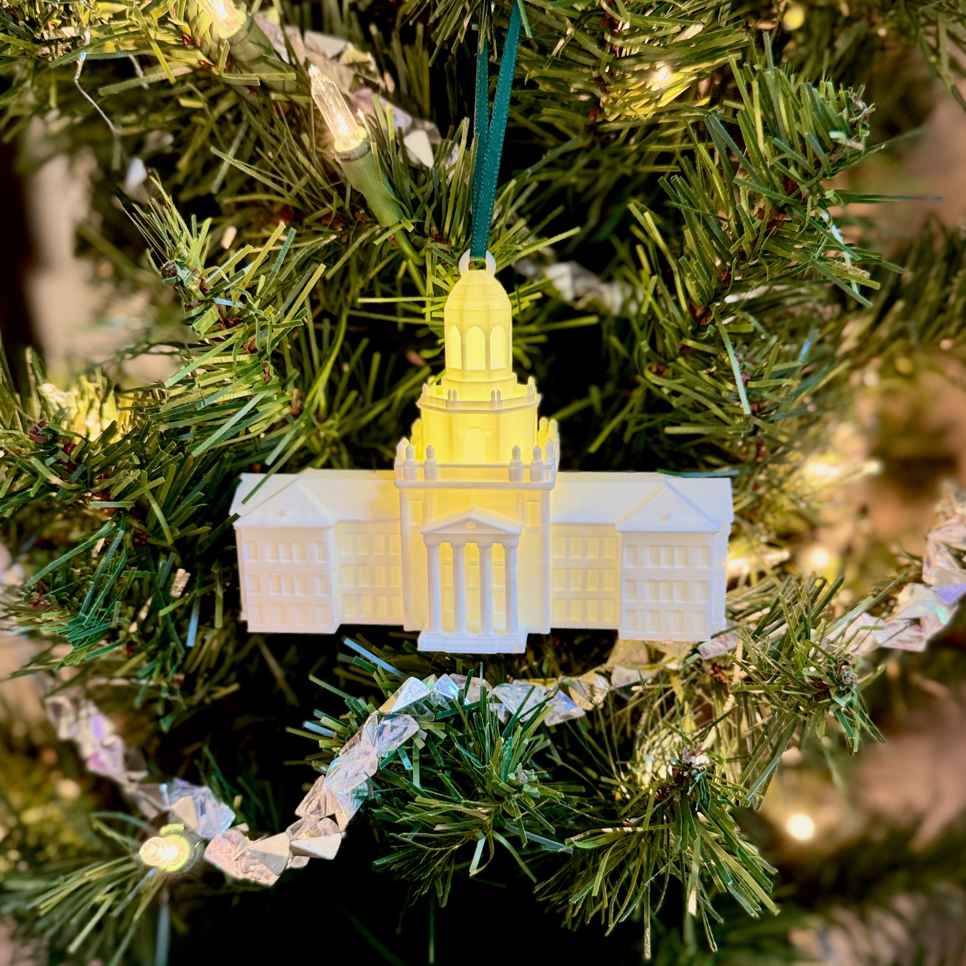 3D-printed Baylor Bears alumni gift ornament glowing on a pine branch with a dark green ribbon.