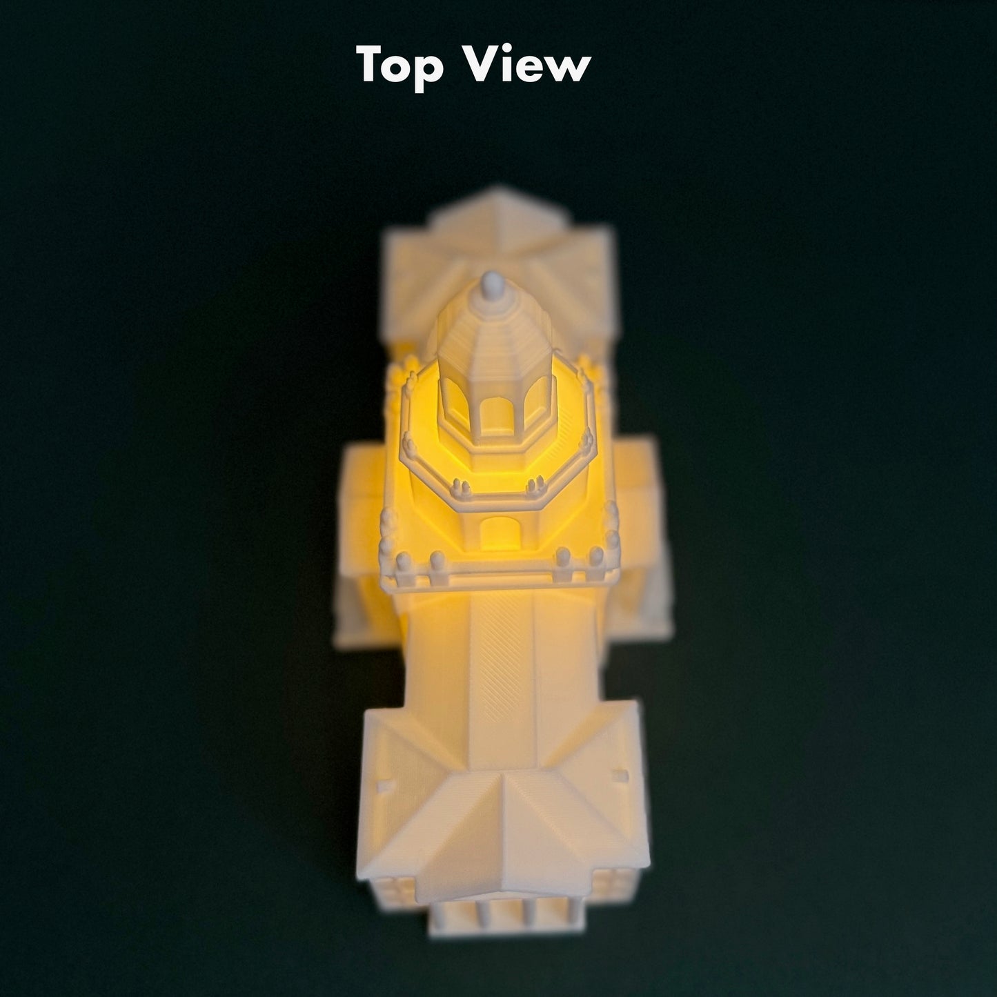 A top-down view of a the Pat Neff LED light for Baylor alumni, shown against a green background.