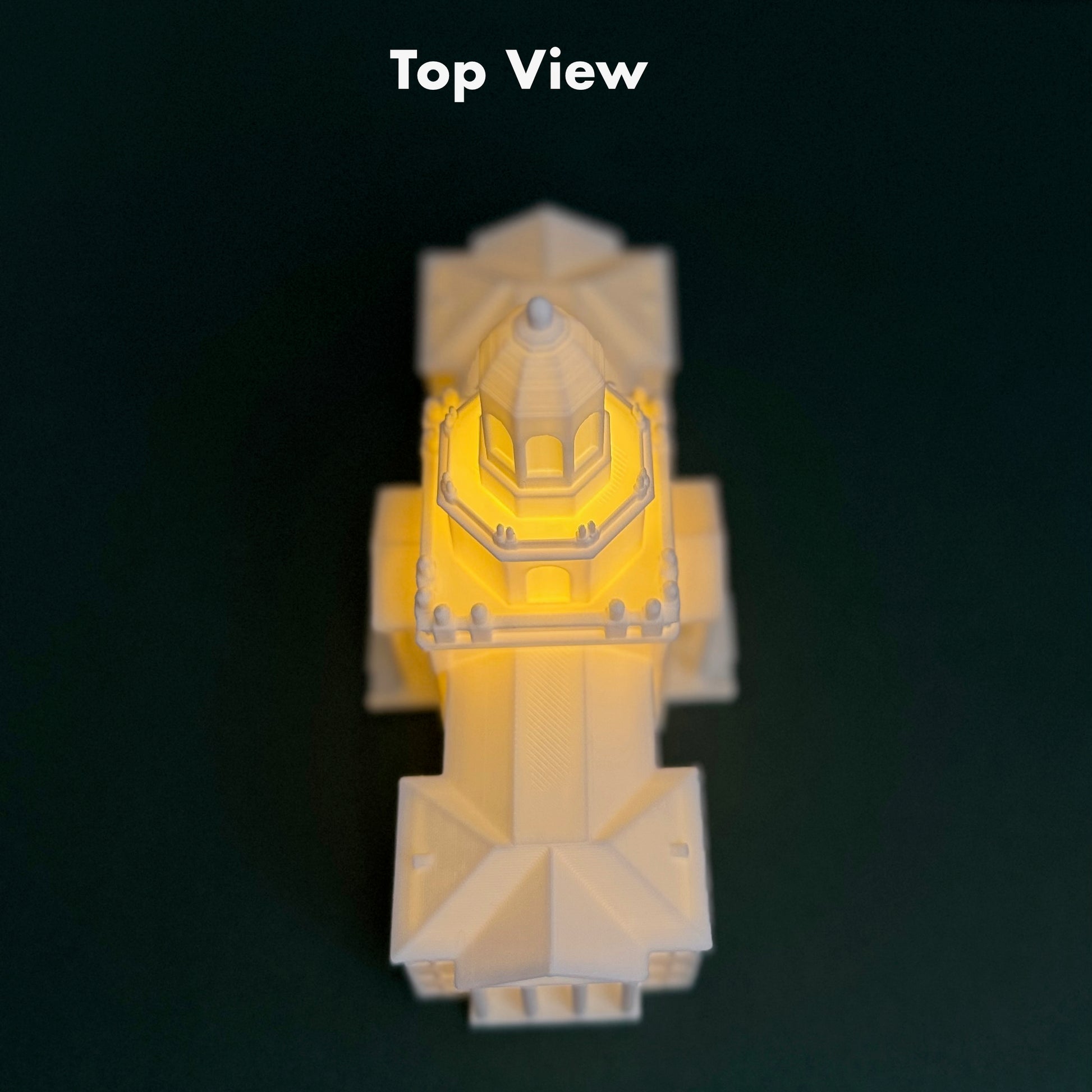 A top-down view of a the Pat Neff LED light for Baylor alumni, shown against a green background.