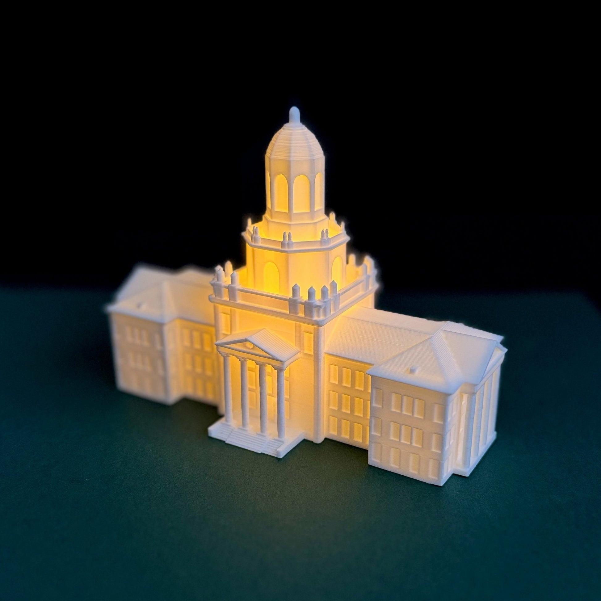 Close-up of the 3D printed architectural details on an illuminated Pat Neff Hall graduation cake topper.