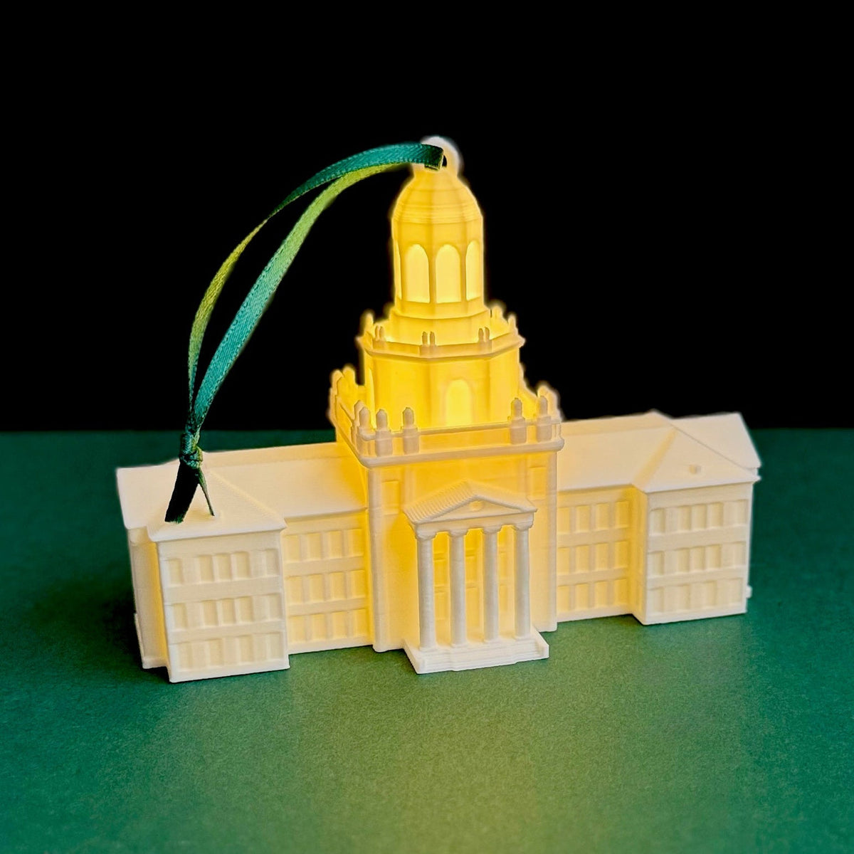 The Baylor University ornament with a light, featuring the Pat Neff Hall building and shown against a green background.