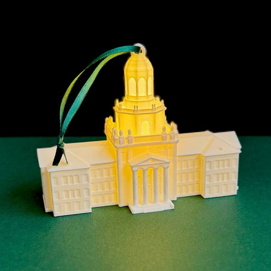 The Baylor University ornament with a light, featuring the Pat Neff Hall building and shown against a green background.