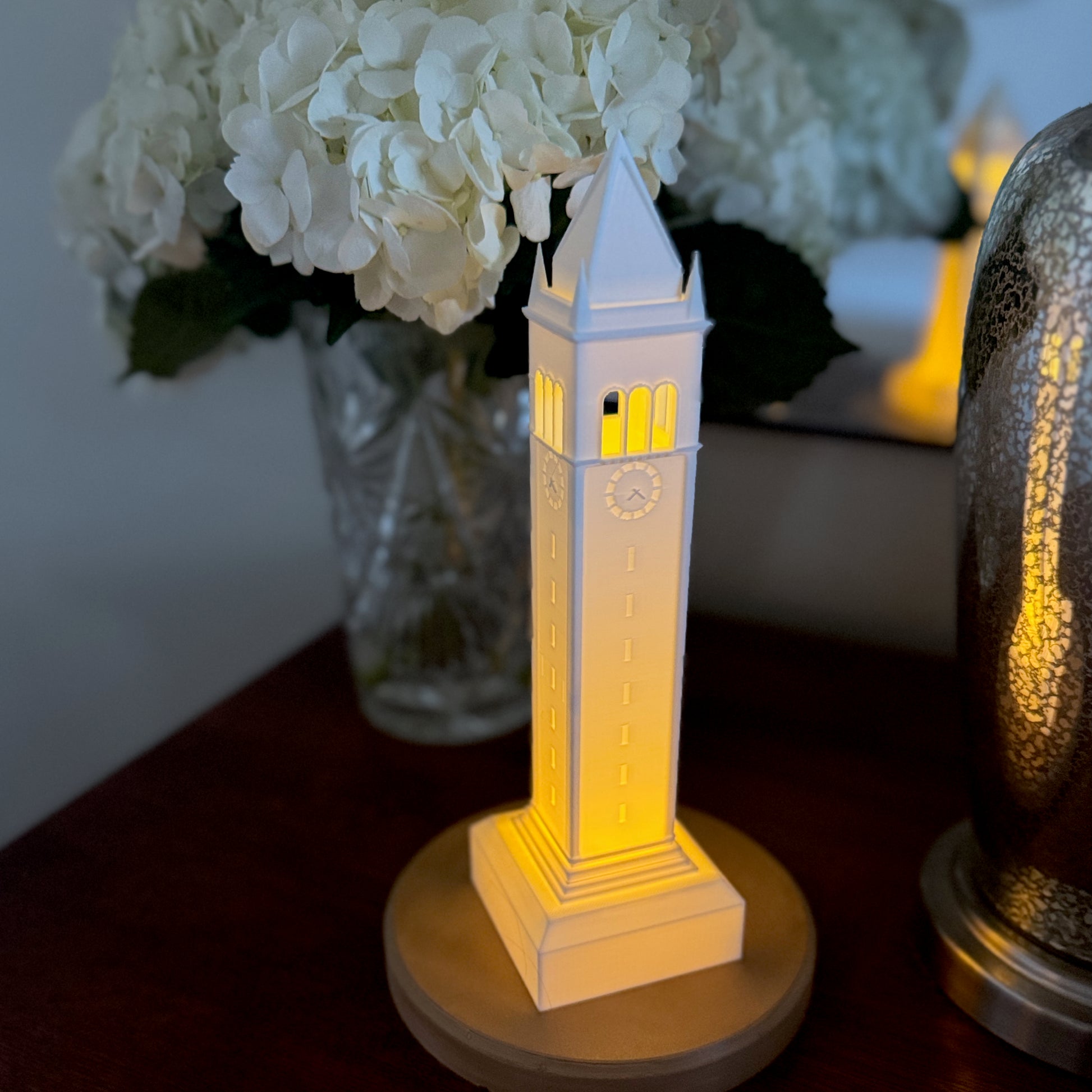 The Berkeley light designed as the Campanile, shown in a dorm room on a side table.