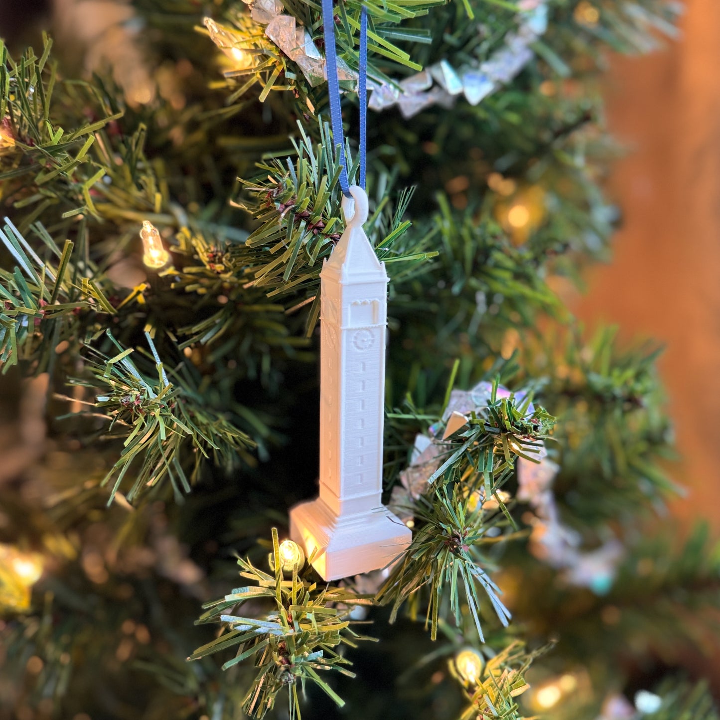 The Berkeley ornament featuring the Campanile, shown on a Christmas tree.