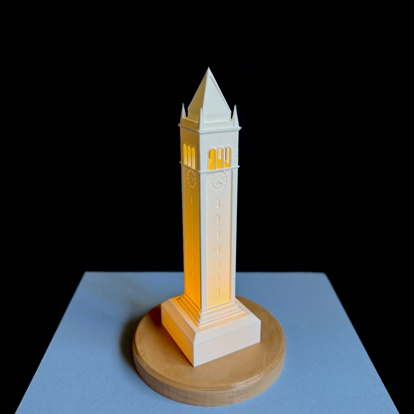 The Berkeley lamp, shown against a blue background and designed as a replica of the Campanile.