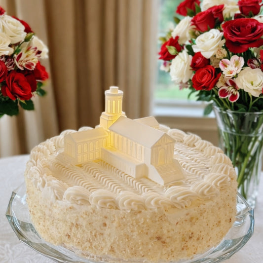 A Carnegie Mellon cake topper featuring the Hamerschlag Hall building and shown on a groom's cake or a graduation cake.