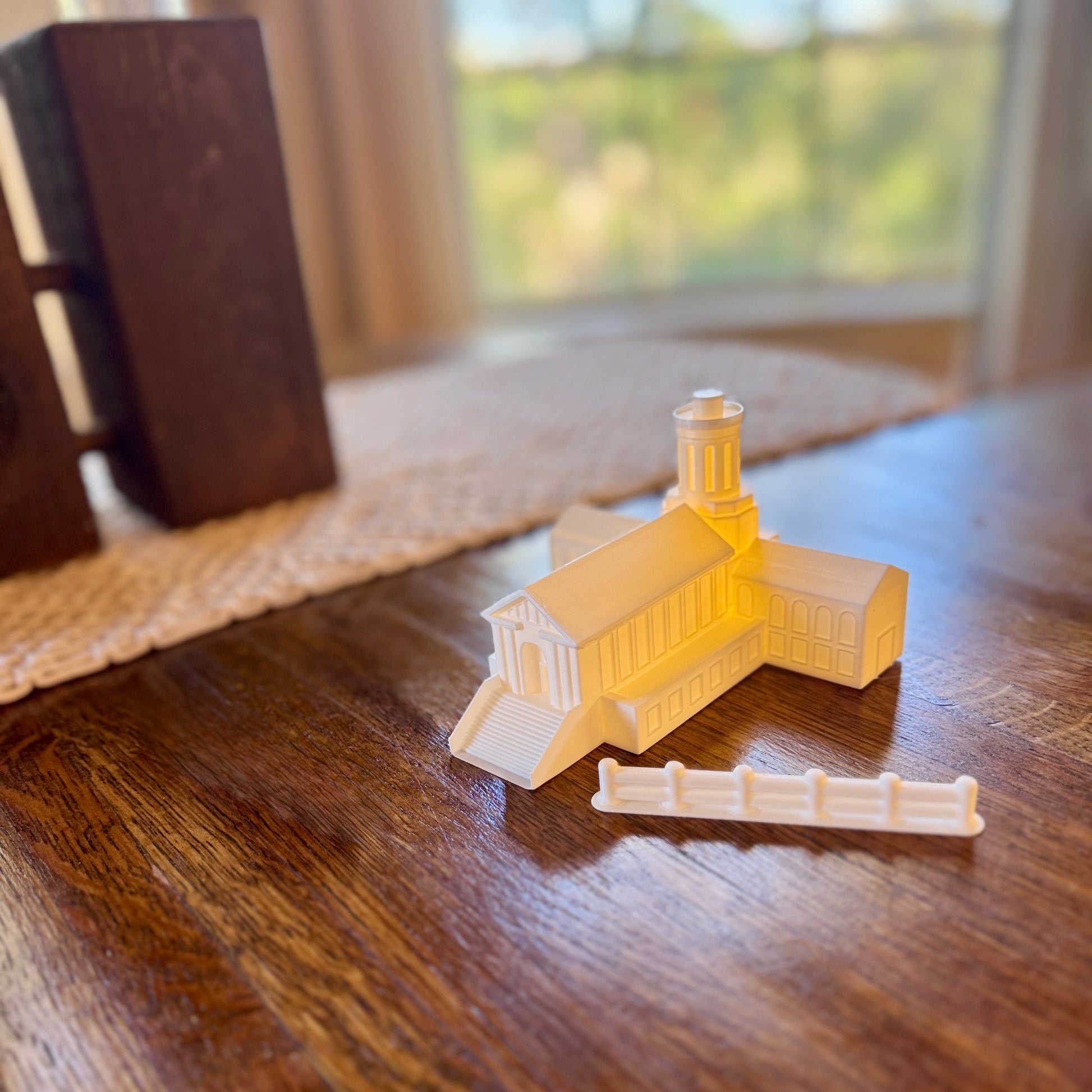 Carnegie Mellon Fence next to a Hamerschlag Hall figurine with an LED light.