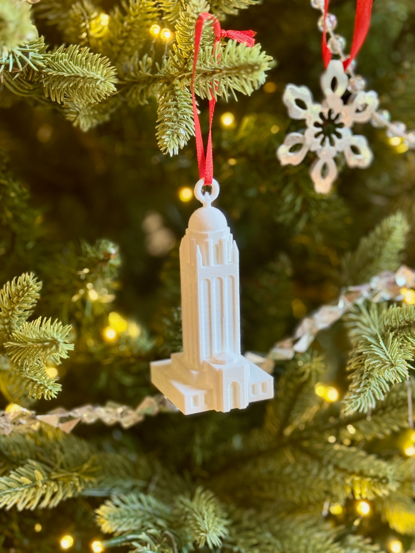 The Stanford college ornament of Hoover tower shown on a tree.