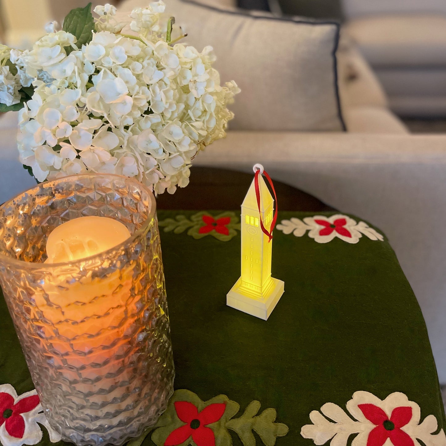 The Cornell ornament with a light, shown in a home decorated for the holidays.