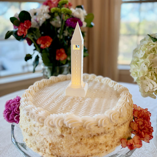 The Cornell cake topper figurine depicting McGraw Tower, shown on a Cornell graduation cake.