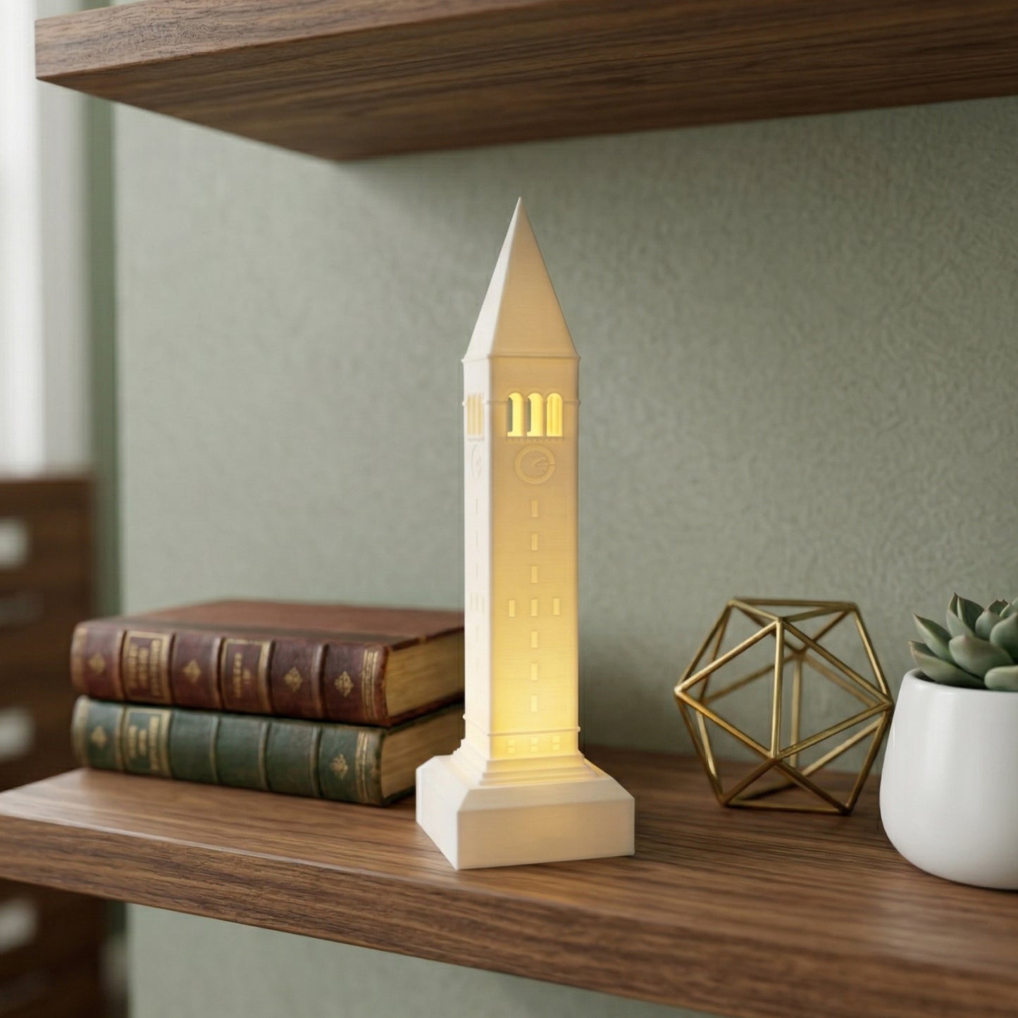 The Cornell McGraw Tower lighted figurine, shown as office decor on a shelf.