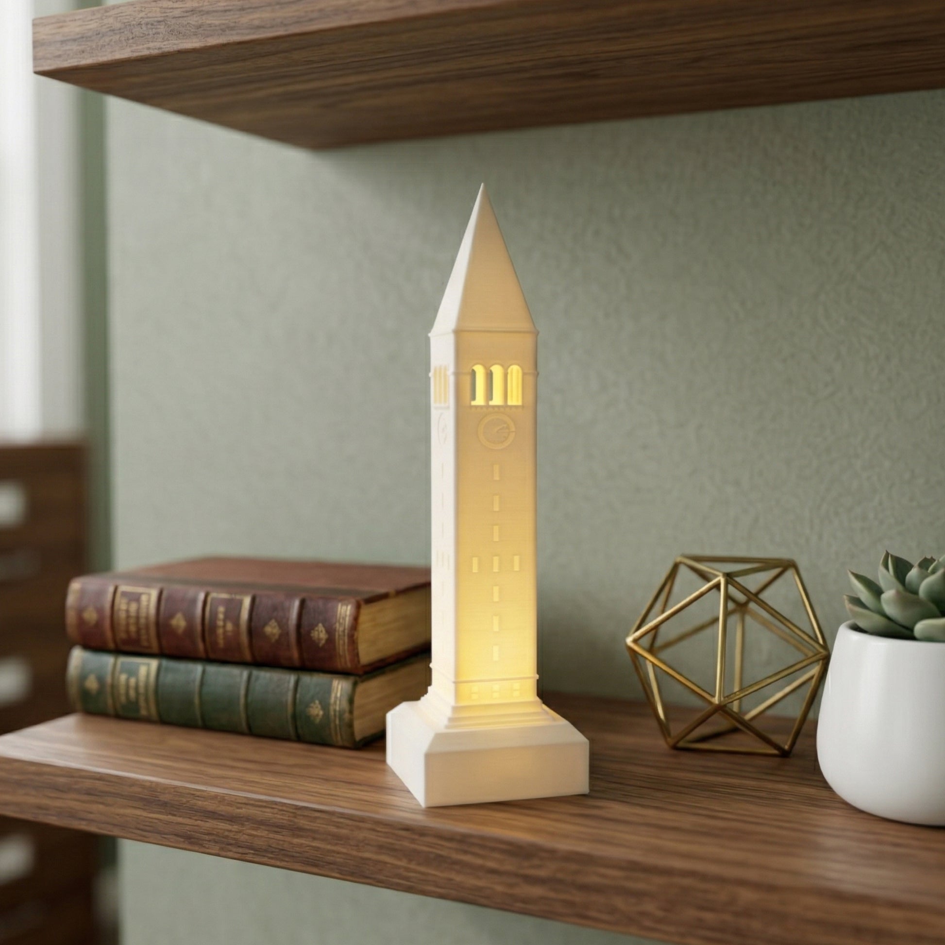 The Cornell McGraw Tower lighted figurine, shown as office decor on a shelf.