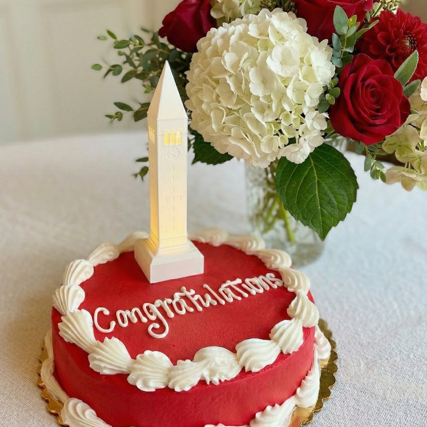 The Cornell cake topper light, shown on a cake for a graduation or alumni celebration.
