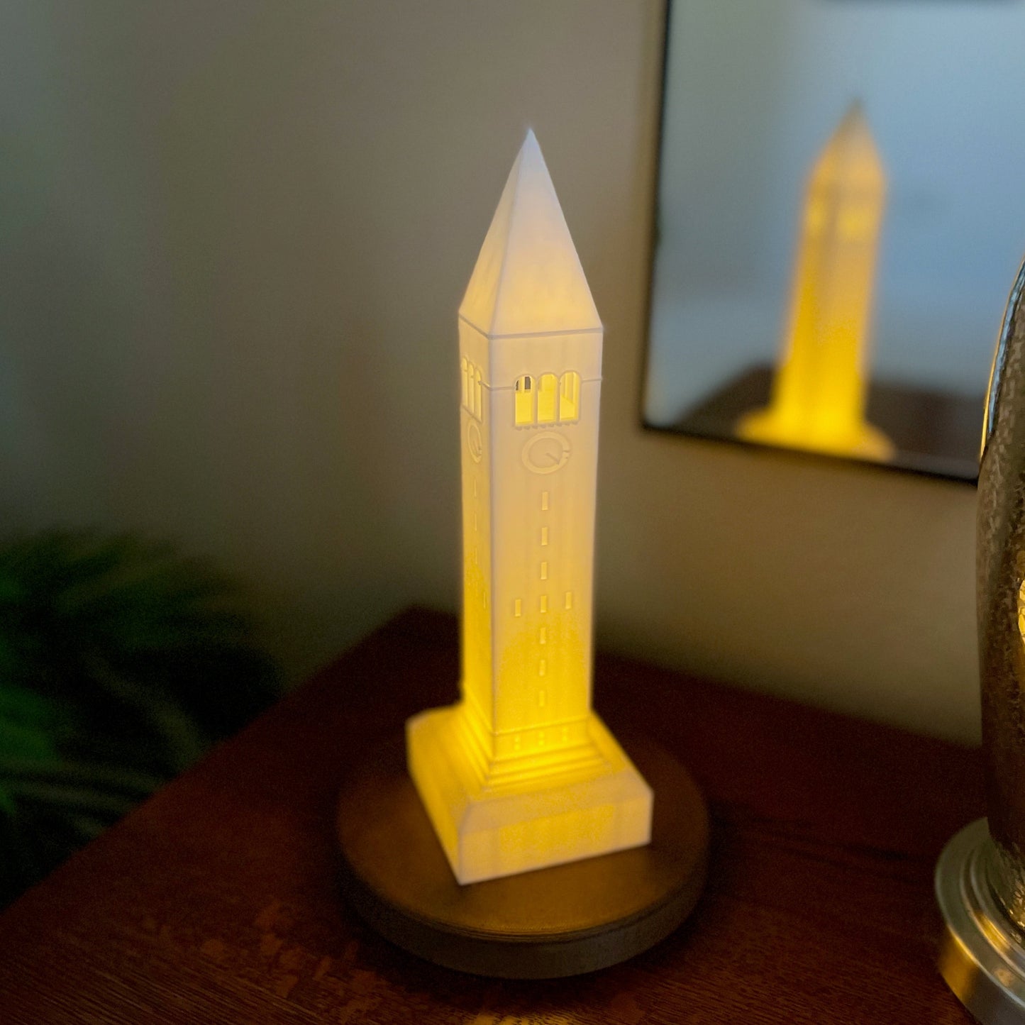 The lighted Cornell figurine, shown on a bedroom side table.