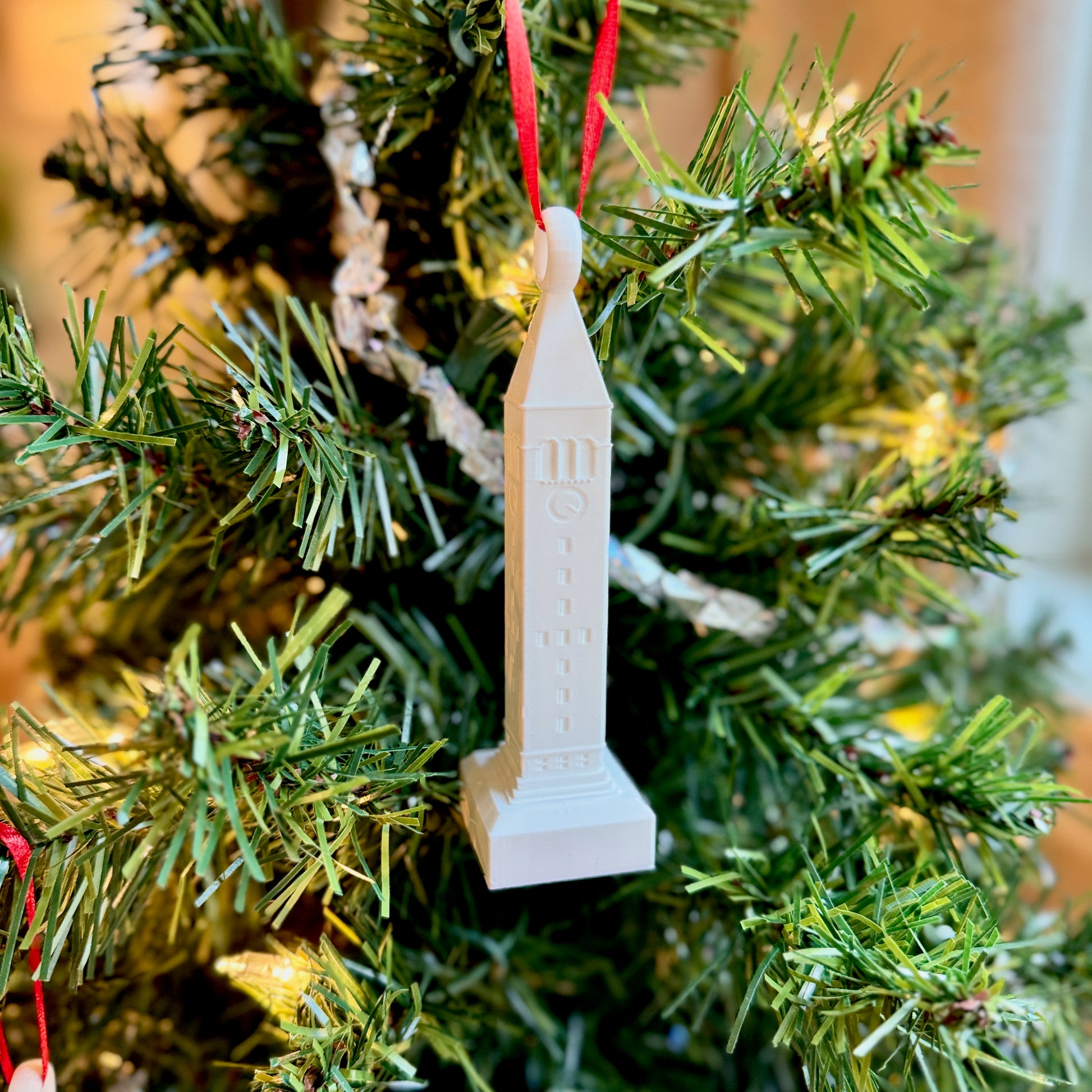 Cornell McGraw Tower ornament with detailed design and red string for hanging.