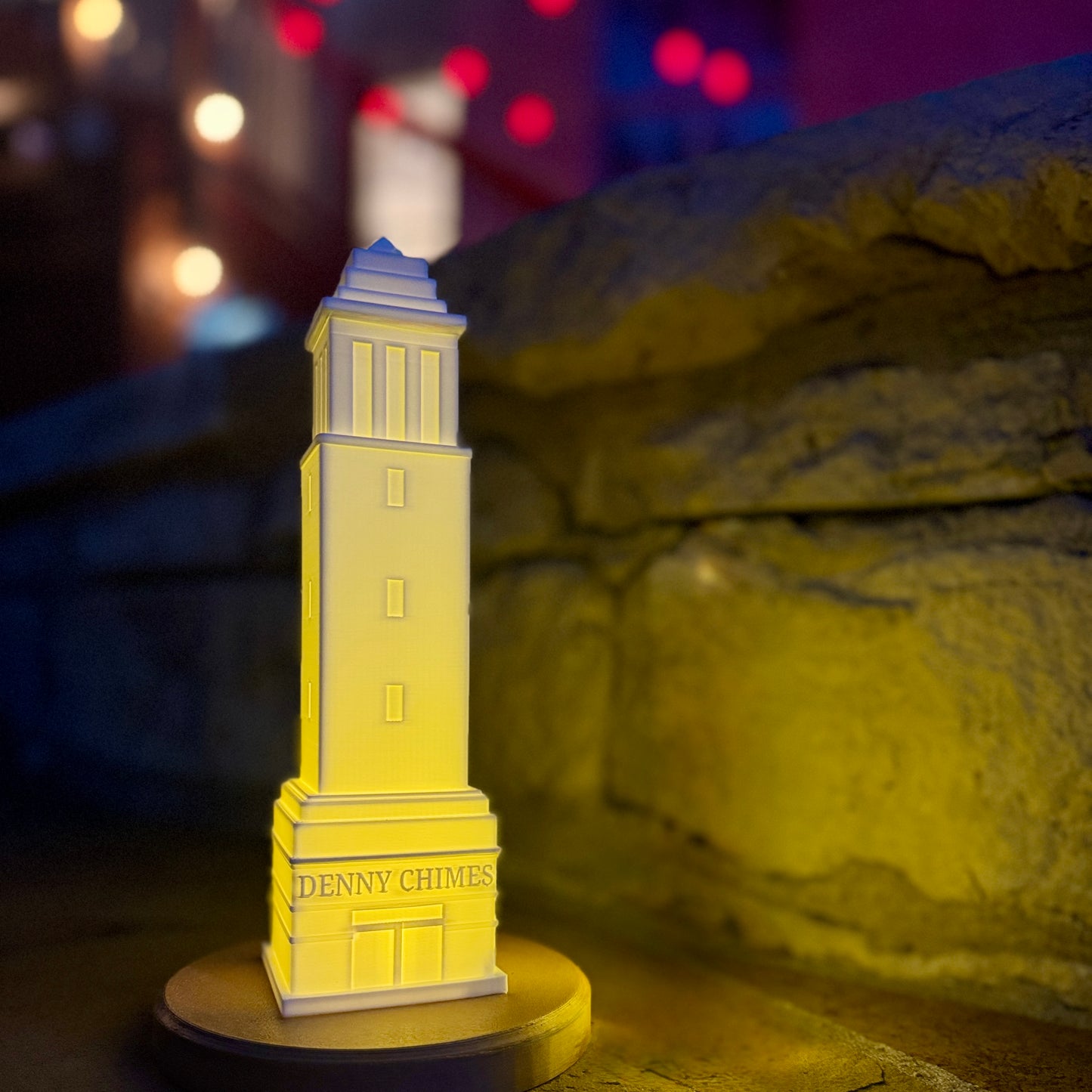 The Denny Chimes Tower light, used as a party decoration for Bama fans, surrounded by Crimson lights.